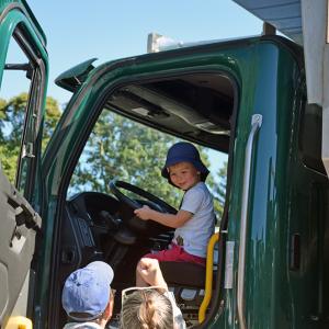 Bo, age 3, enjoys one of the DPW trucks. 
