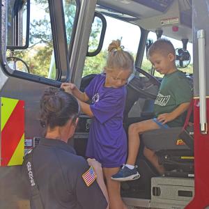 Declan and Claire learn more about the fire trucks. 