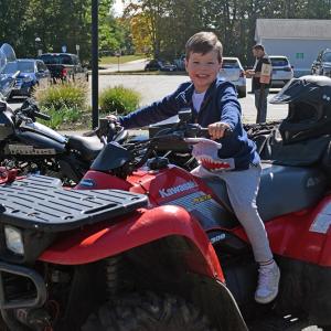 Theodore Nelson, age 3, gets to try out a (stationary) motorcycle. 