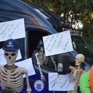 The DCTV van all decorated with skeleton puns. 