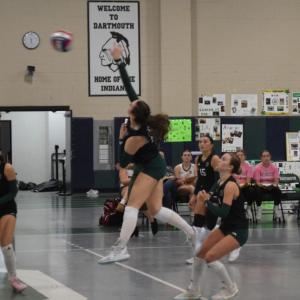 Madeline	Enos hits the ball over the net. 