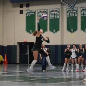 Kasey Pomfret leaps to hit the ball. 