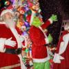 The Grinch and Clauses wave to the crowd in front of the buoy tree. Photo by Michael T. Morris Photography