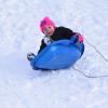 Avarey Landgrof, 7, tips over in her sled.
