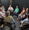 A group of people sitting in a circle wanting to do improv!